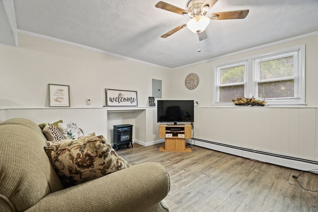 14 Porter Street Billerica, MA 01821 - Photo 28 of 33 a living room with furniture a flat screen tv and a large window