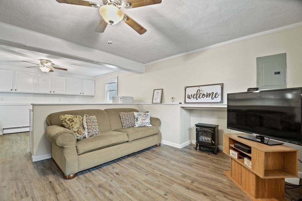 14 Porter Street Billerica, MA 01821 - Photo 29 of 33 a living room with furniture and a flat screen tv