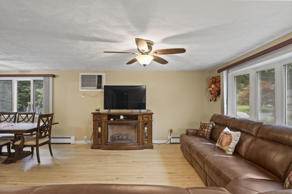 14 Porter Street Billerica, MA 01821 - Photo 5 of 33 a living room with furniture a flat screen tv and a large window