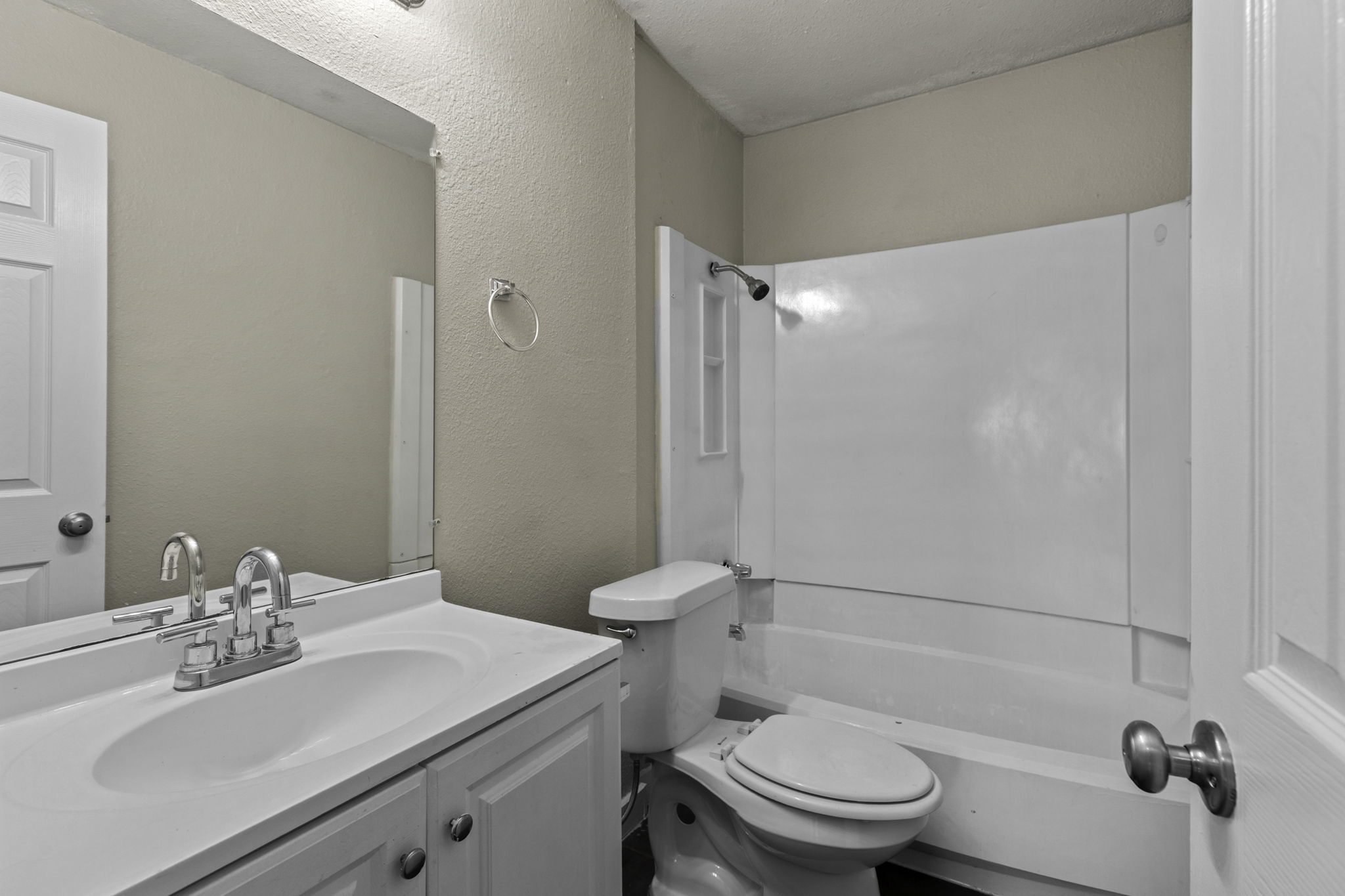 6110 Wheless Cove, Unit F Austin, TX 78723 - Photo 9 of 12 Full bath featuring a textured wall, vanity, bathing tub / shower combination, and a textured ceiling