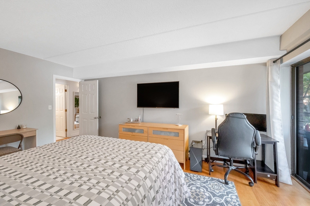 159 Main Street, Unit 15B Stoneham, MA 02176 - Photo 14 of 25 a bedroom with a bed and a flat screen tv