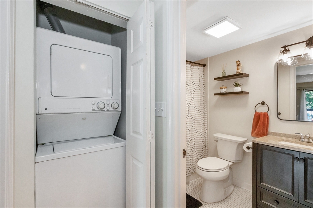 159 Main Street, Unit 15B Stoneham, MA 02176 - Photo 15 of 25 a bathroom with a toilet sink and mirror