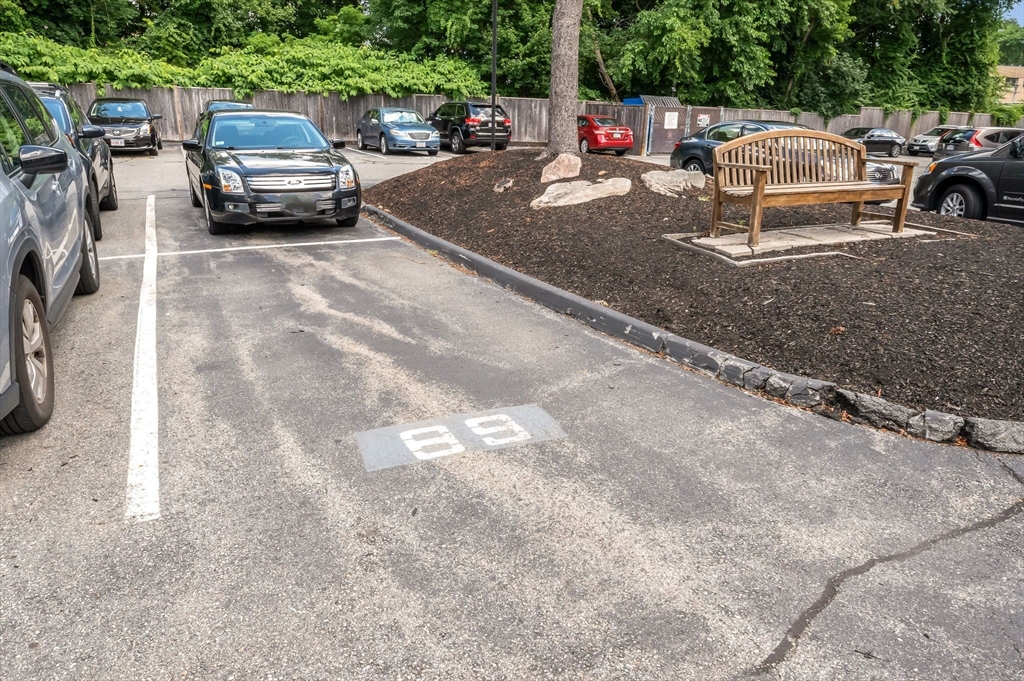 159 Main Street, Unit 15B Stoneham, MA 02176 - Photo 18 of 25 a view of a cars park in front of a house