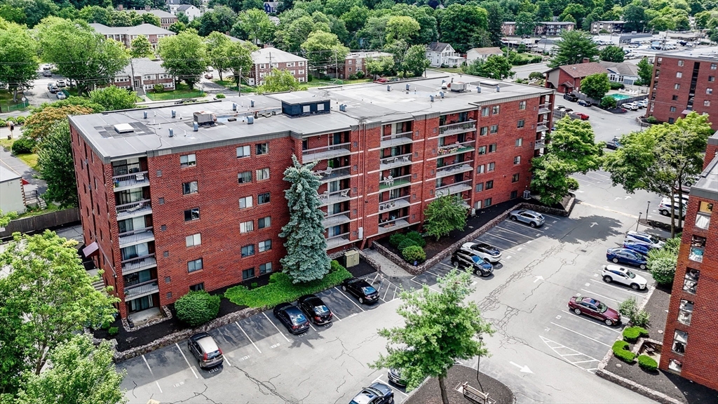 159 Main Street, Unit 15B Stoneham, MA 02176 - Photo 19 of 25 an aerial view of a building with garden space and street view