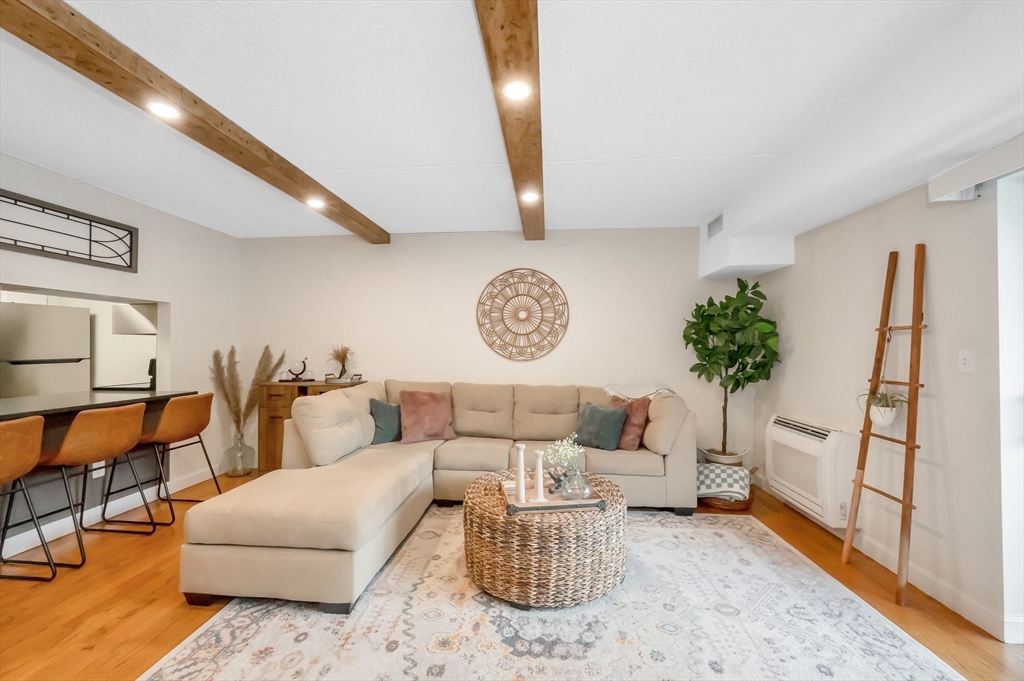 159 Main Street, Unit 15B Stoneham, MA 02176 - Photo 7 of 25 a living room with furniture and a rug