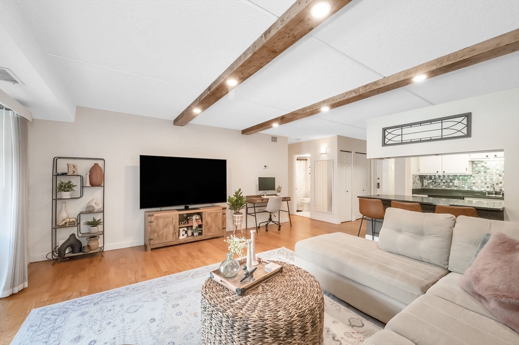 159 Main Street, Unit 15B Stoneham, MA 02176 - Photo 9 of 25 a living room with furniture and a flat screen tv