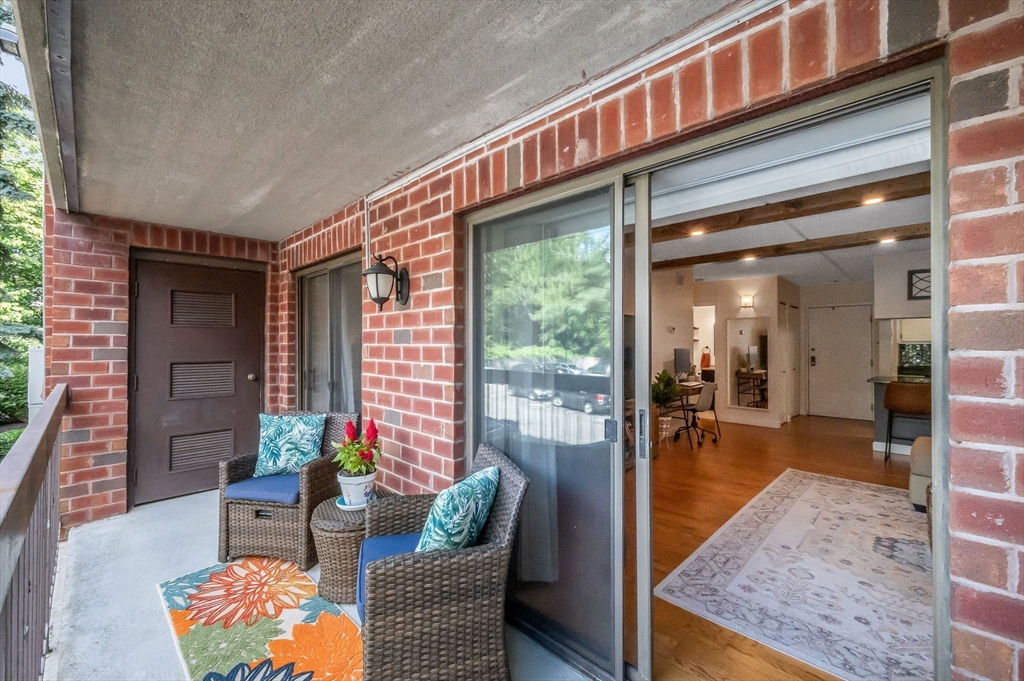 159 Main Street, Unit 15B Stoneham, MA 02176 - Photo 10 of 25 a outdoor living space with furniture and a potted plant