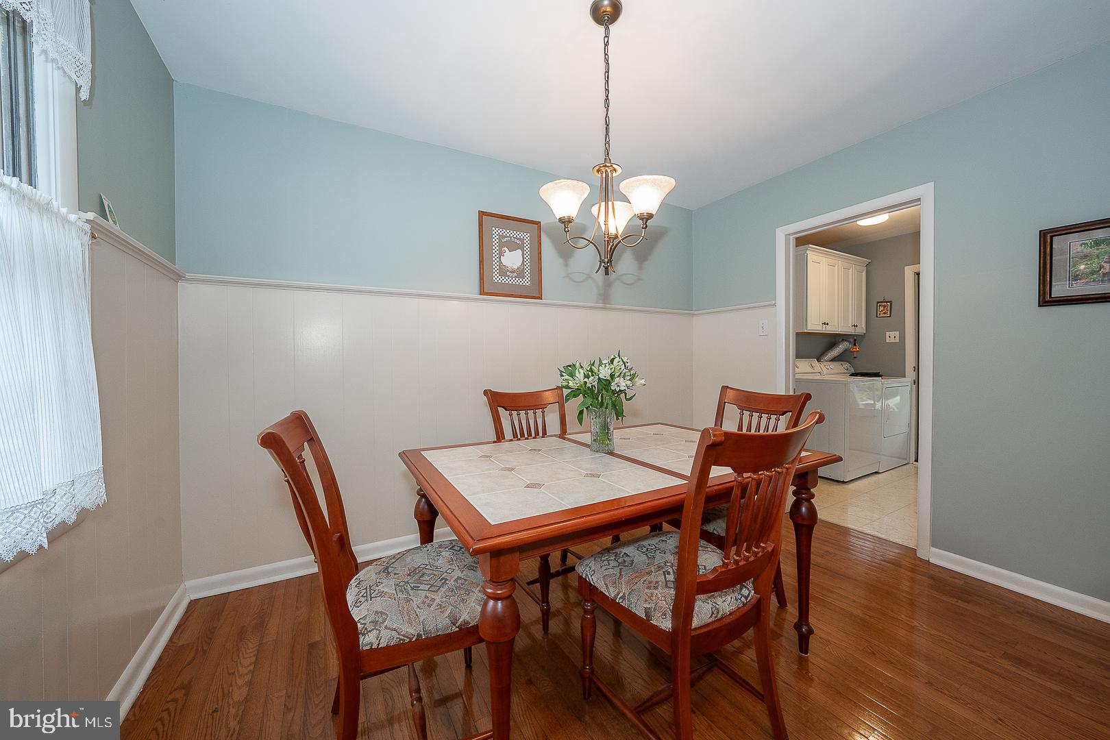 430 Upper Gulph Road Strafford, PA 19087 - Photo 9 of 32 a view of a dining room with furniture wooden floor and a chandelier