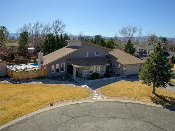 a view of a house with swimming pool and sitting area