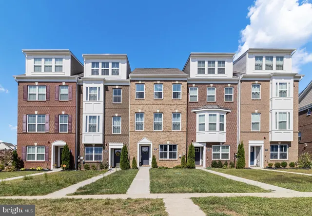 a front view of a building with a yard