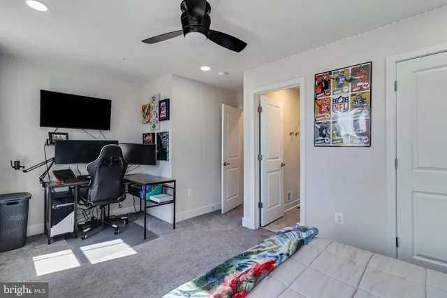 a view of a livingroom with workspace and a window