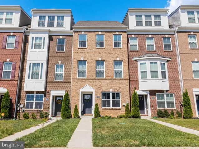 a front view of a building with a yard