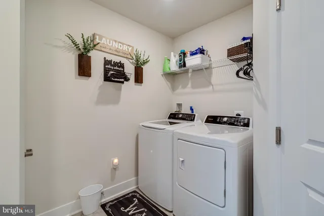 a view of storage and utility room with washer and dryer