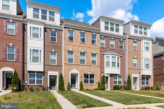 a front view of a building with a yard