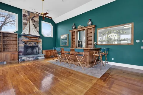 a living room with furniture a flat screen tv and kitchen view