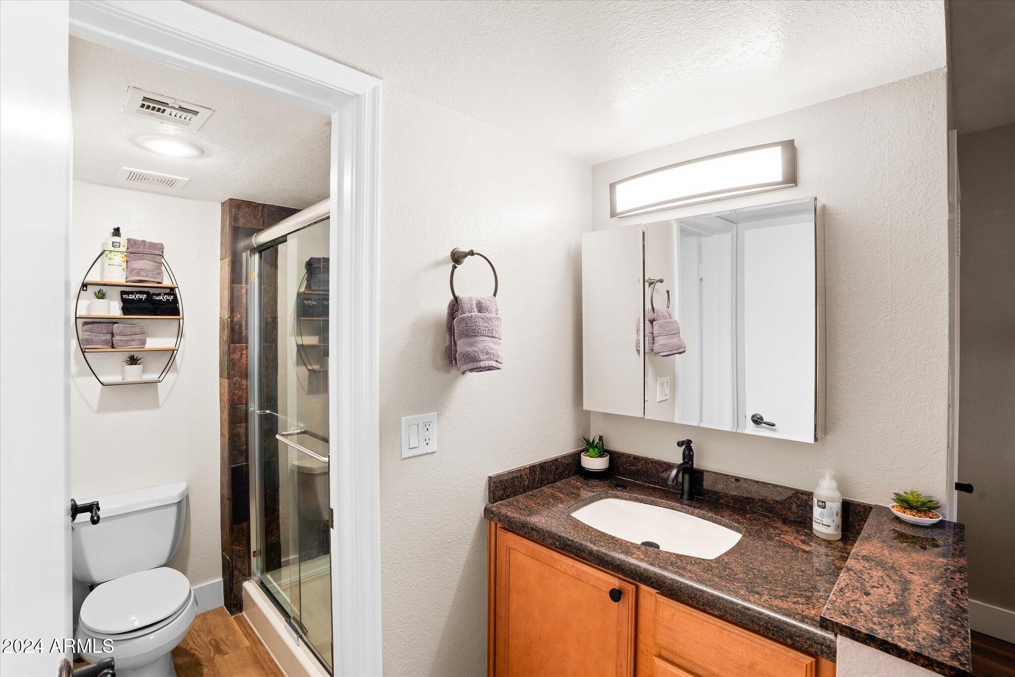 533 West Guadalupe Road, Unit 1063 Mesa, AZ 85210 - Photo 35 of 57 a bathroom with a granite countertop sink toilet and shower