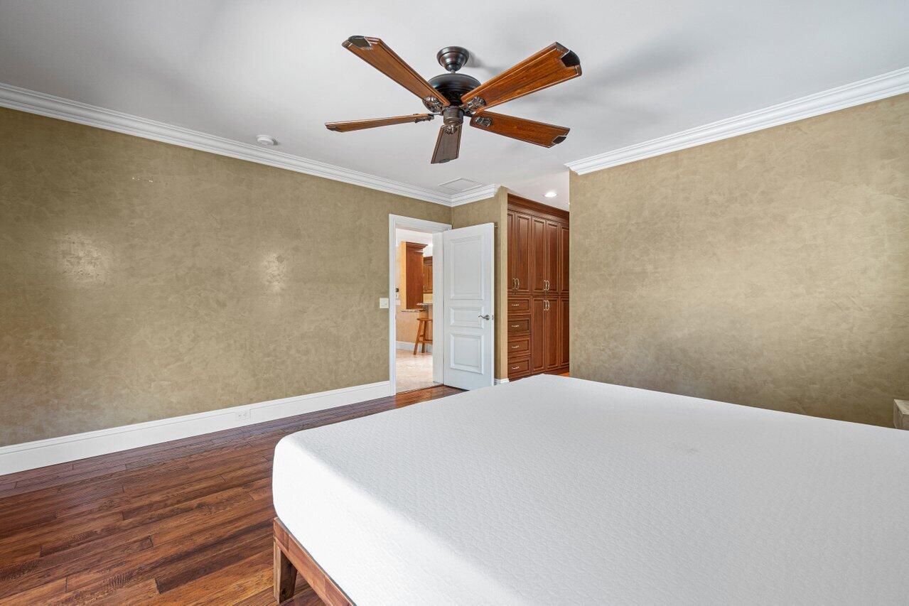870 Northwest 7th Street Boca Raton, FL 33486 - Photo 23 of 37 a bed room with wooden floor and ceiling fan