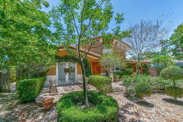 a front view of a house with garden