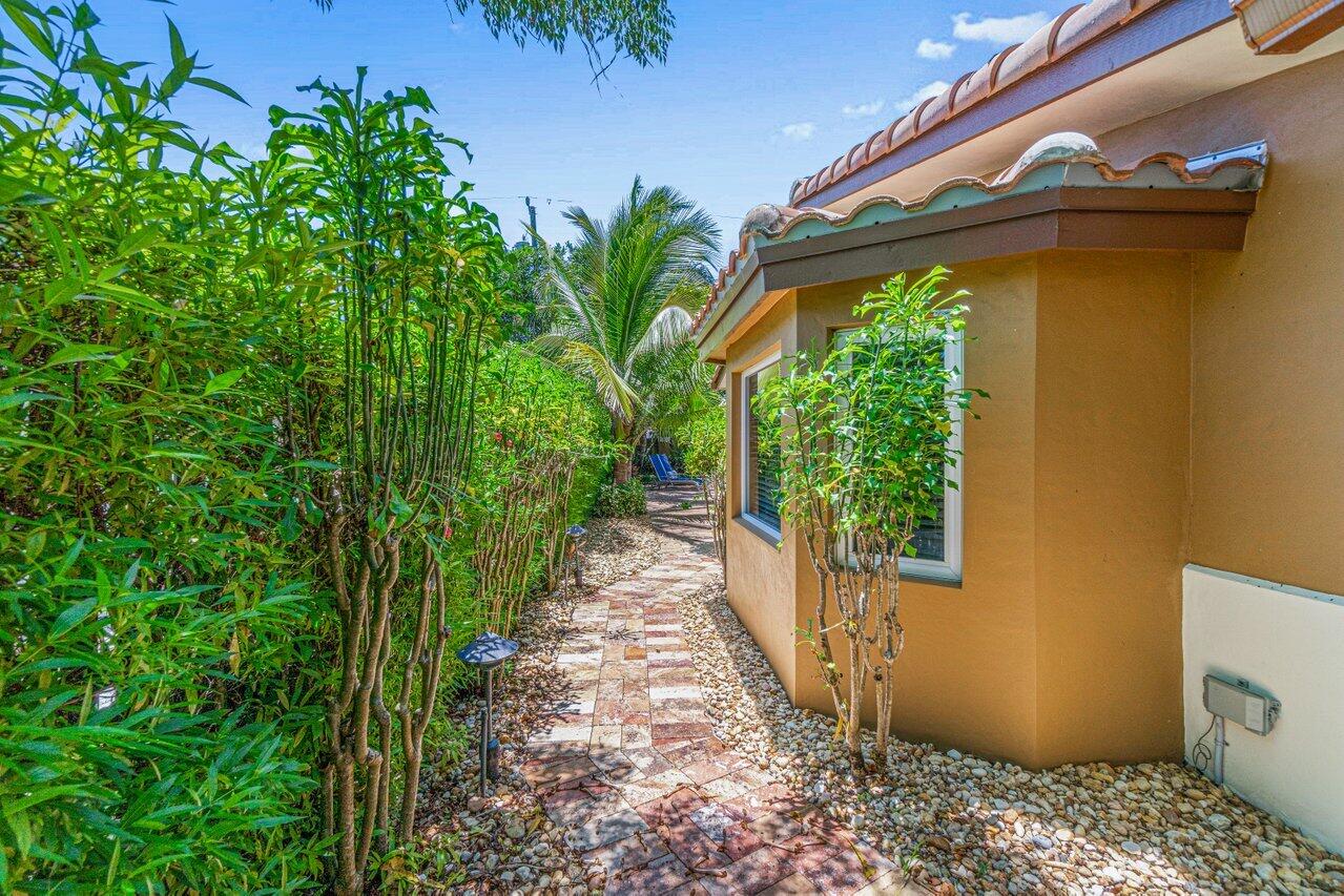 870 Northwest 7th Street Boca Raton, FL 33486 - Photo 37 of 37 a view of a pathway of a house with potted plants