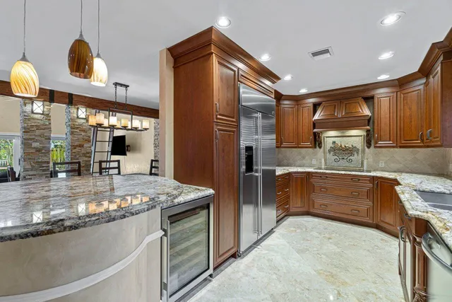 a kitchen with stainless steel appliances granite countertop a sink and cabinets