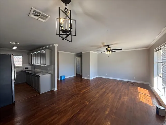 a view of a kitchen with a sink wooden floor and a window