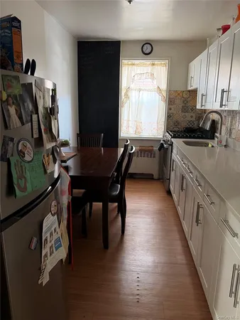 a kitchen with granite countertop a sink appliances and cabinets