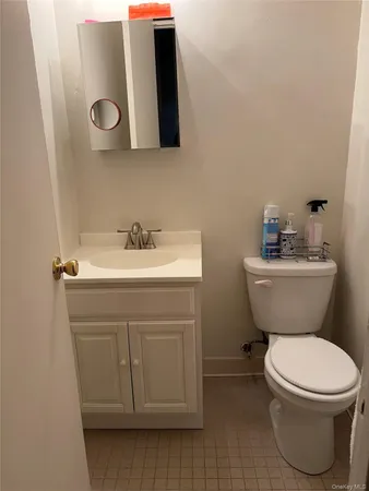a bathroom with a sink mirror vanity and toilet
