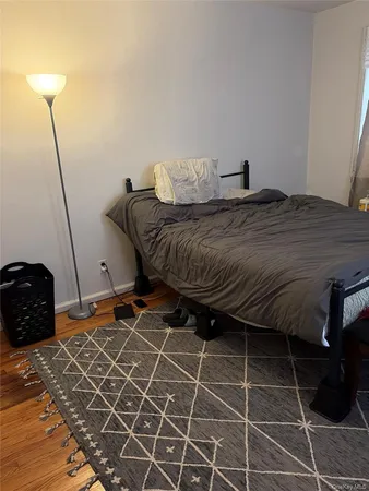 a bedroom with a bed and a mirror