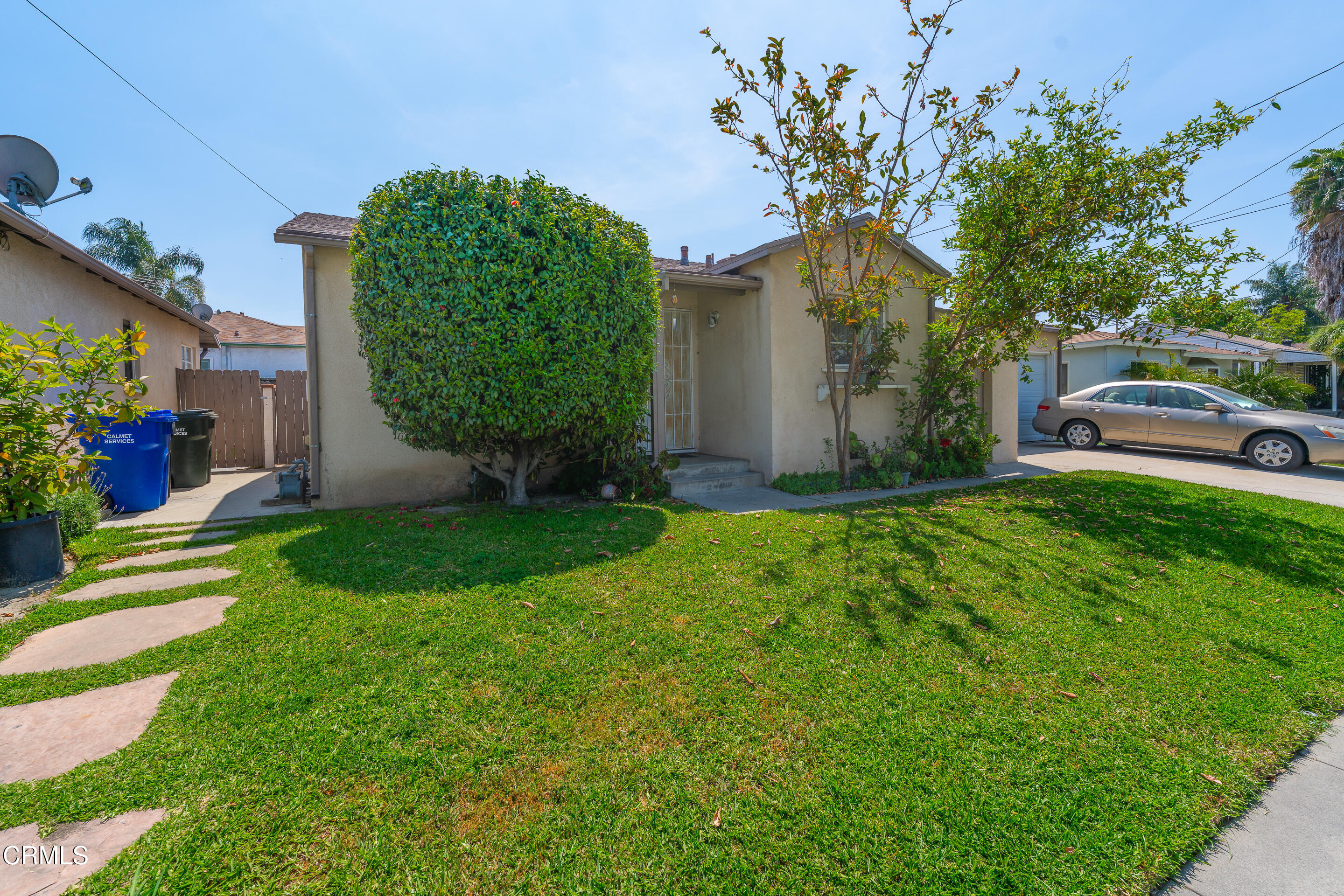 8202 5th Street Downey, CA 90241 - Photo 5 of 10 a view of a house with a big yard and potted plants