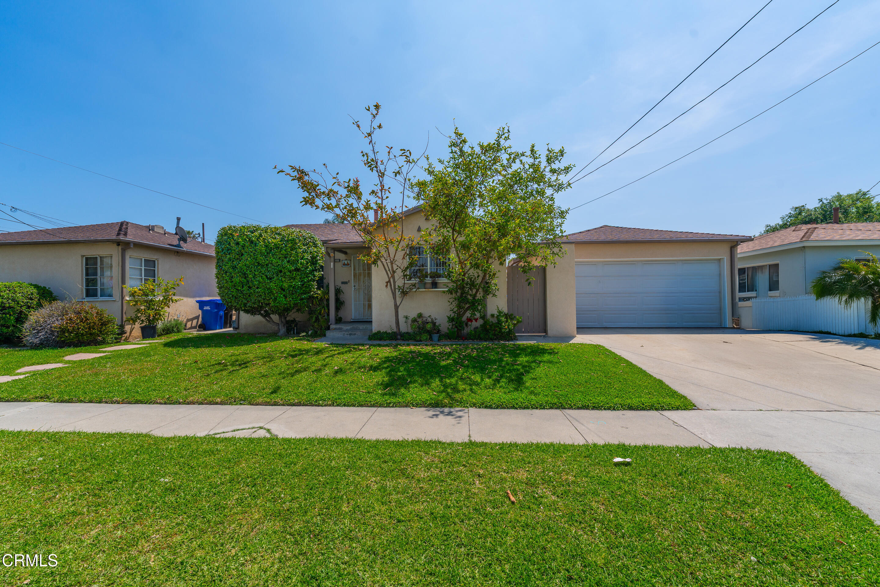 8202 5th Street Downey, CA 90241 - Photo 7 of 10 a front view of a house with a garden and plants