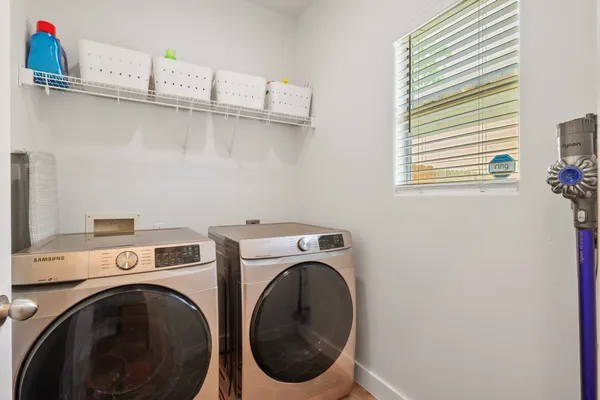 a kitchen with a sink a refrigerator and wooden floor