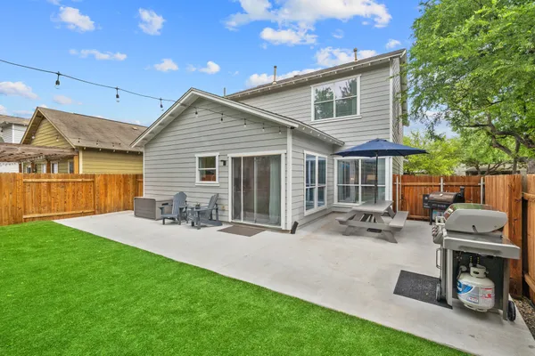 a view of a patio with a table chairs and a yard