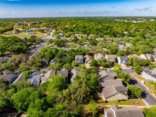 an aerial view of a house with a yard and garden