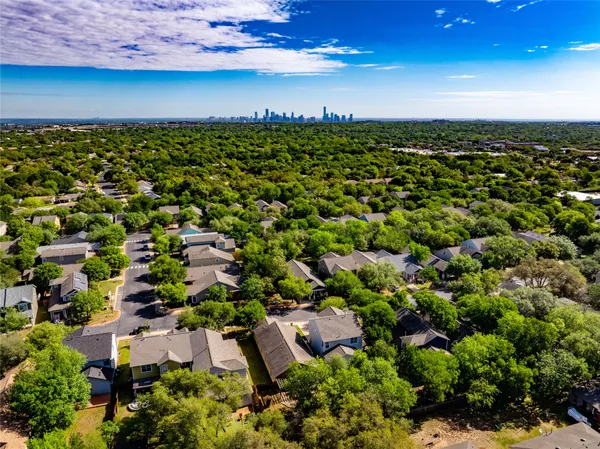 an aerial view of a houses with a yard