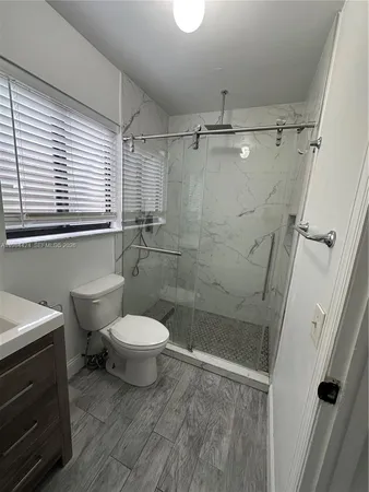 a bathroom with a toilet sink and shower