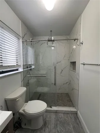 a bathroom with a toilet and a shower