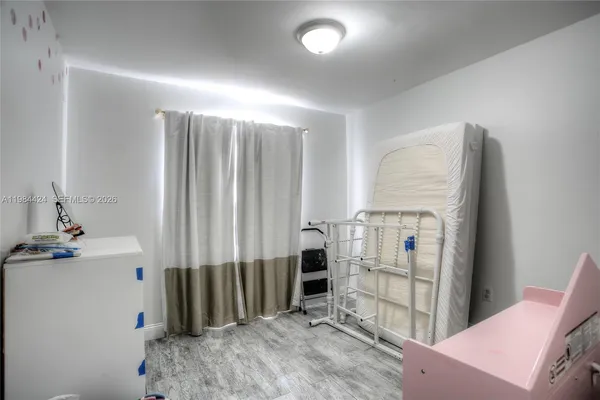 a view of hallway with mirror and a window