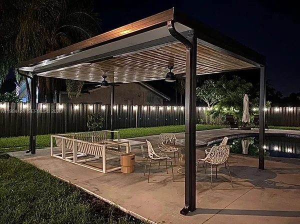 a view of an outdoor sitting area with wooden fence