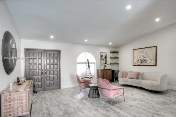 a living room with furniture and a large window