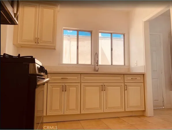 a kitchen with stainless steel appliances granite countertop a refrigerator and cabinets
