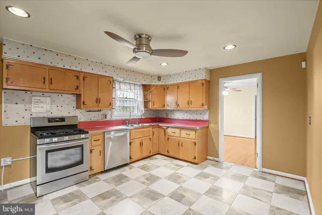 a kitchen with a stove a sink and a refrigerator