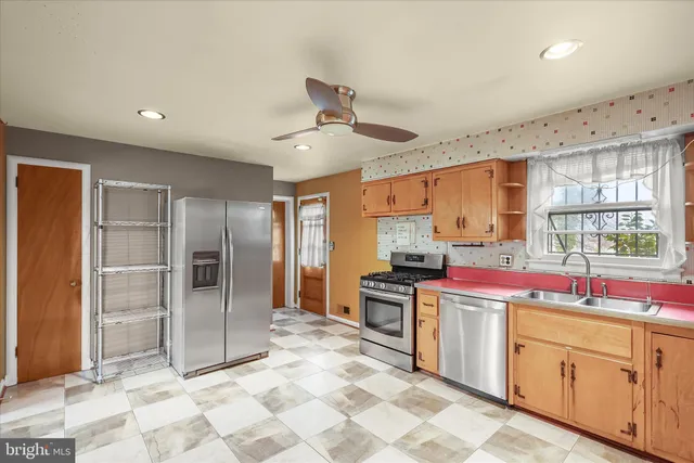a kitchen with stainless steel appliances granite countertop a sink and cabinets