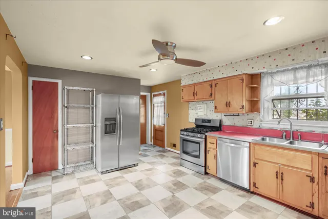 a kitchen with a sink stove and refrigerator