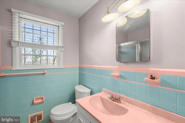 a bathroom with a sink a toilet and mirror