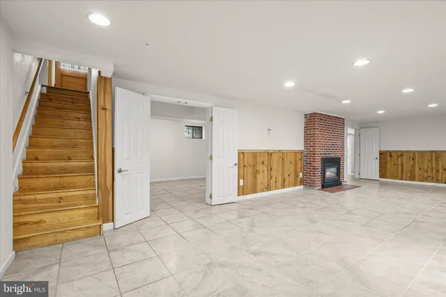 a view of an empty room with a fireplace