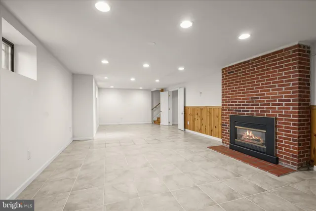 a view of empty room with a fireplace