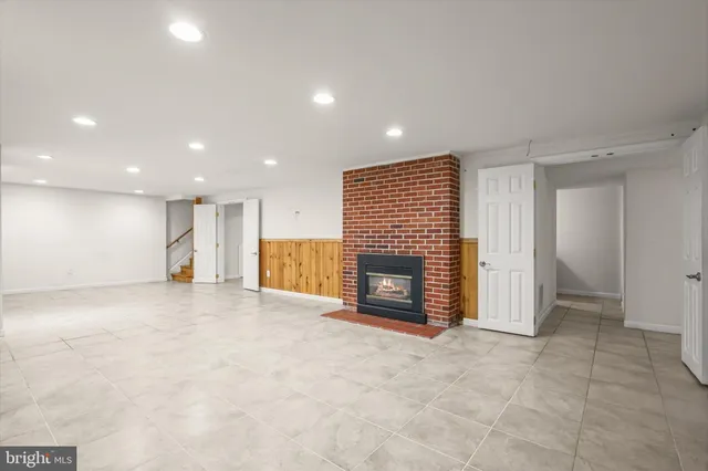 a view of empty room with a fireplace