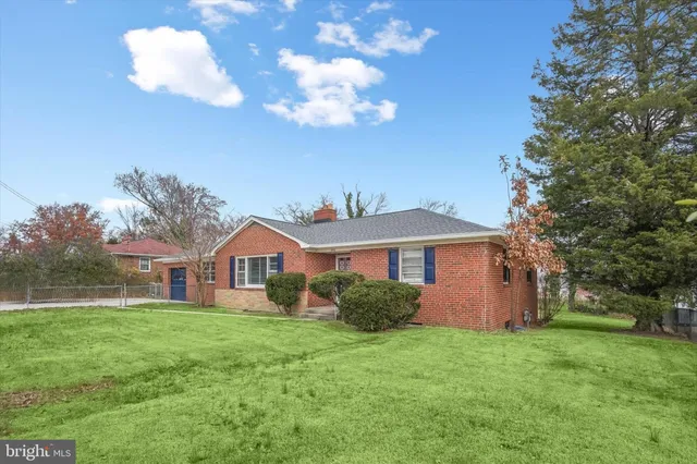 a front view of house with yard and green space