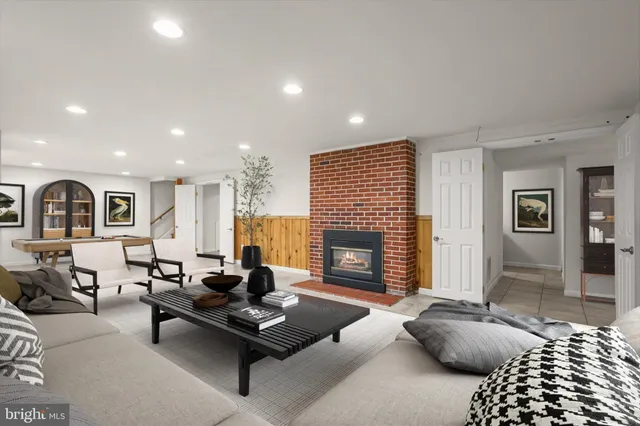 a living room with furniture rug and fireplace