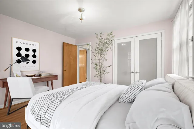 a bedroom with a large bed and a chandelier